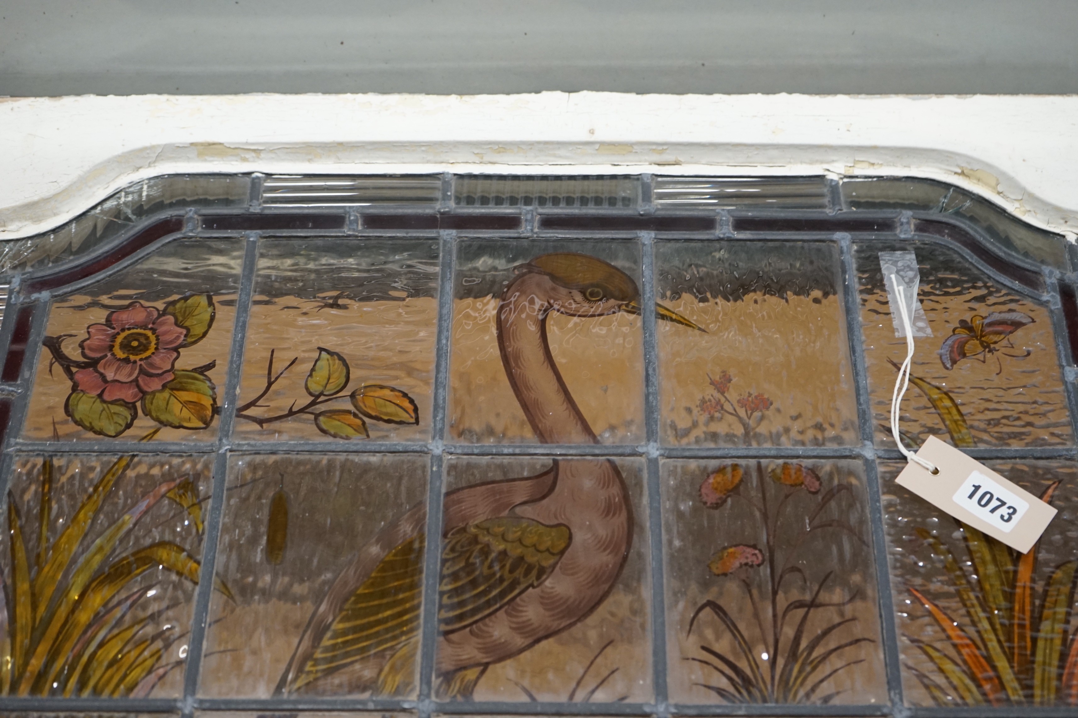 A late Victorian stained leaded glass panel depicting a heron amongst reeds, width 71cm, height 61cm